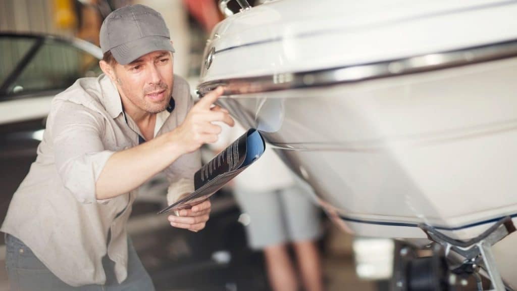 a person inspecting his boat motor