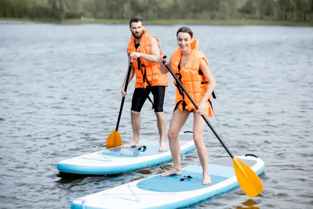 a couple paddle boarding