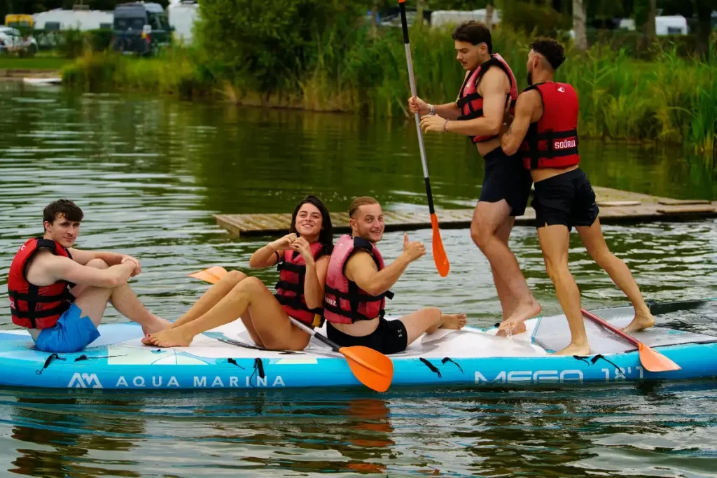 a group of friends doing paddle boarding activities
